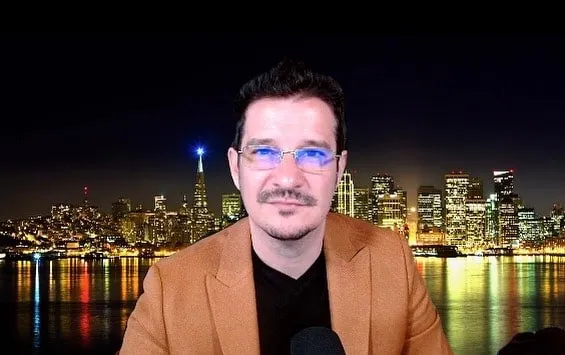 Sebastian Cochinescu speaks on camera against a nighttime city skyline.