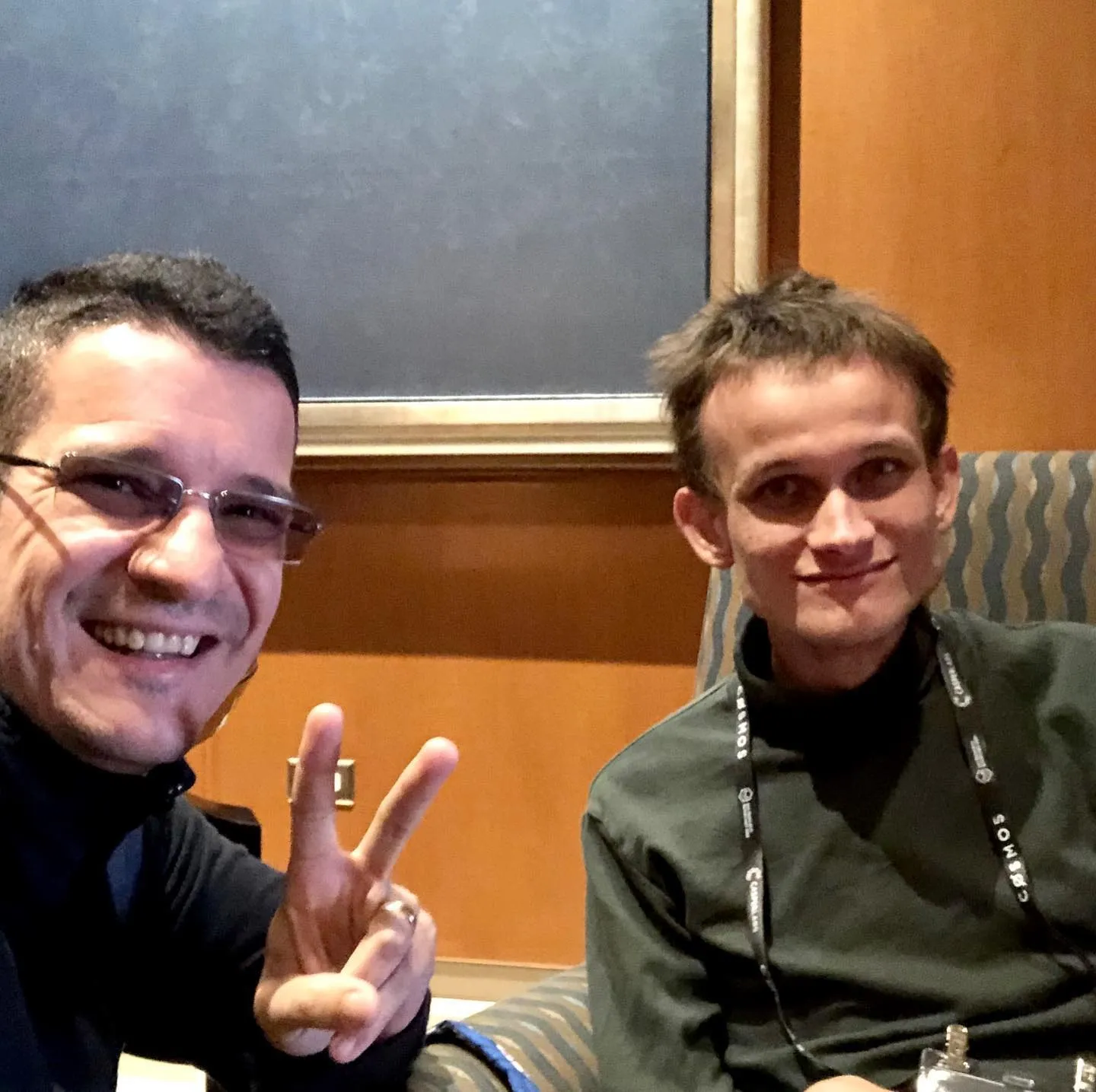 Sebastian Cochinescu takes a smiling selfie with Vitalik Buterin at a conference.